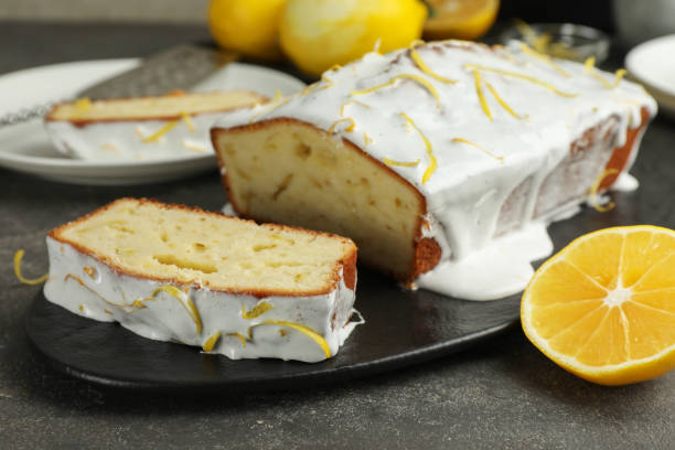 istock Tasty lemon cake with glaze and citrus fruit on table, closeup 2186678859