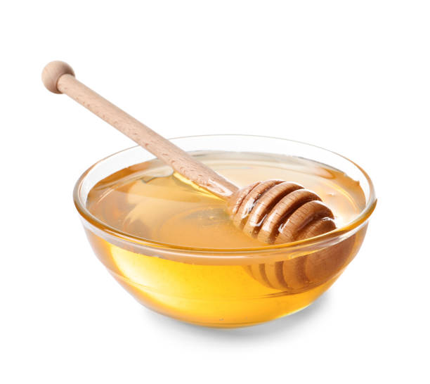 istock Tasty honey in bowl and dipper isolated on white 2186678873