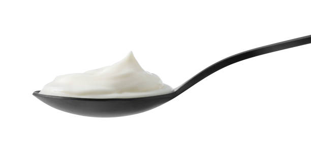 istock One black spoon with sour cream isolated on white 2186679924