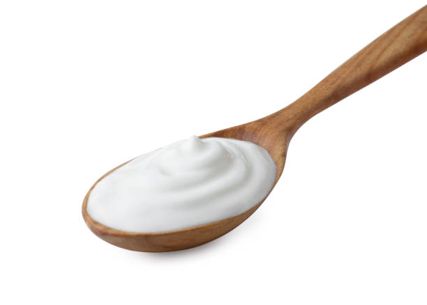 istock One wooden spoon with sour cream isolated on white 2186680008