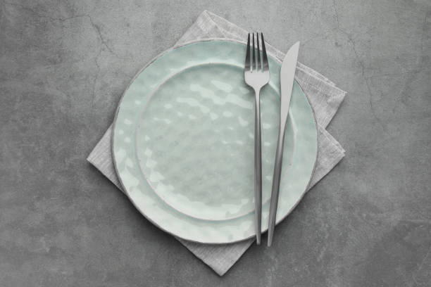 istock Clean plate, cutlery and napkin on grey table, top view 2186680010
