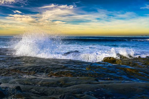 istock Water crashing on the rocky shoreline in La Jolla causing a spray with a beautiful blue sky 2186682106