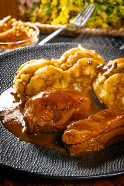istock Traditional German braised pork cheeks in brown sauce. 2186682423