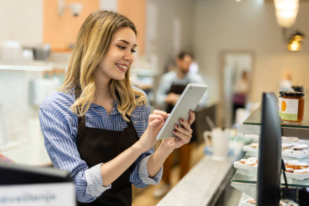 istock Smiling young baker at the checkout counter. 2186683422