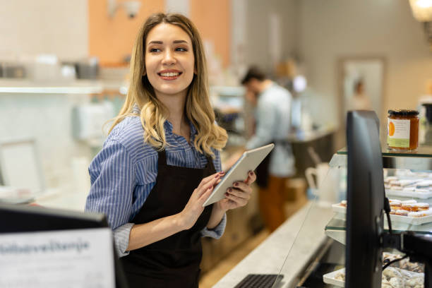 istock Smiling young baker at the checkout counter. 2186683600