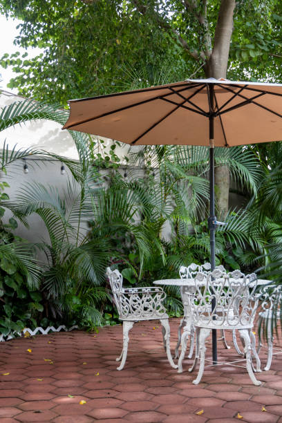 istock garden with a table and chairs with an umbrella in the morning 2186683607