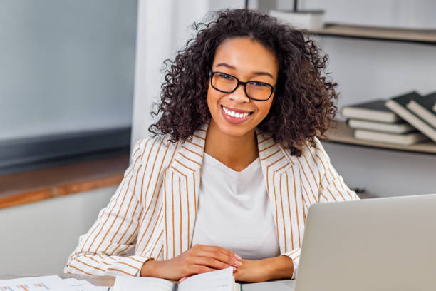 istock Confident Businesswoman Smiling at Work Desk 2186683890