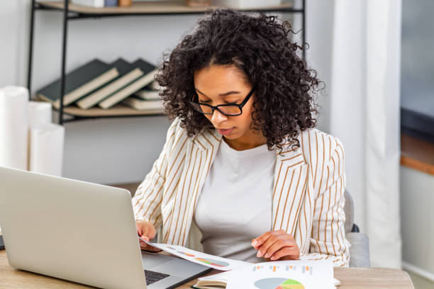 istock Focused Businesswoman Working with Laptop and Documents 2186683893