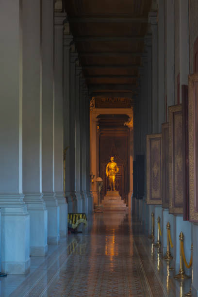 Interior of the Royal Palace in Phnom Phen Cambodia- with statue framed by a row of piers