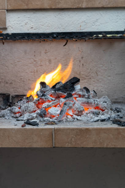 istock stone grill with lit charcoal and a flame 2186684016