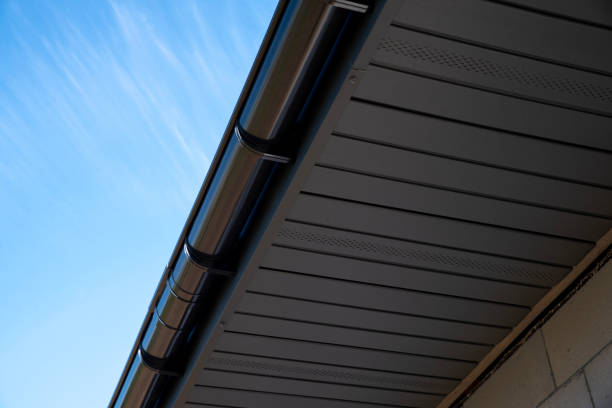 istock Gray perforated metal soffit on a house with gutter system 2186685730