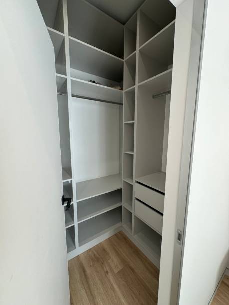 istock Modern walk-in closet with organized shelving and minimalist design 2186685797