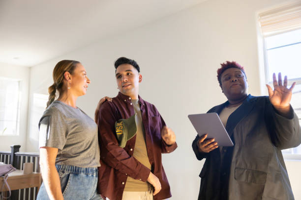 istock real estate agent showing house 2186685911