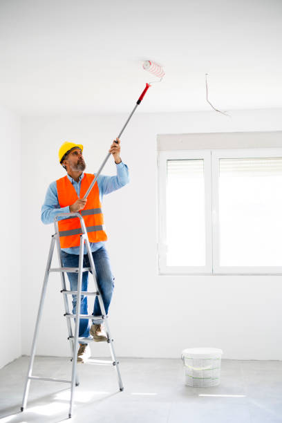 istock Man painting wall at home 2186686138