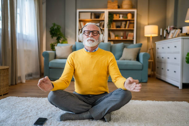 istock Mature senior man practice guided meditation manifestation at home 2186692530