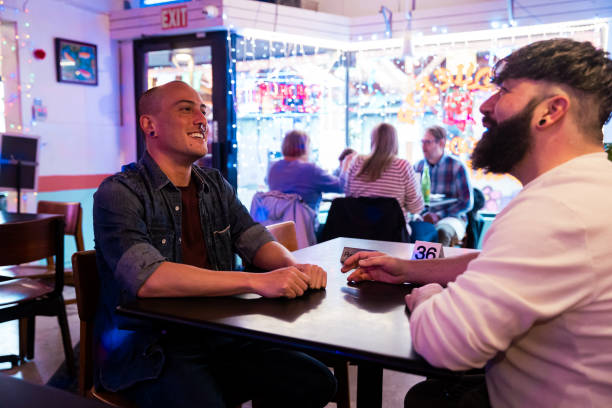 istock Gay couple eating at restaurant 2186692754
