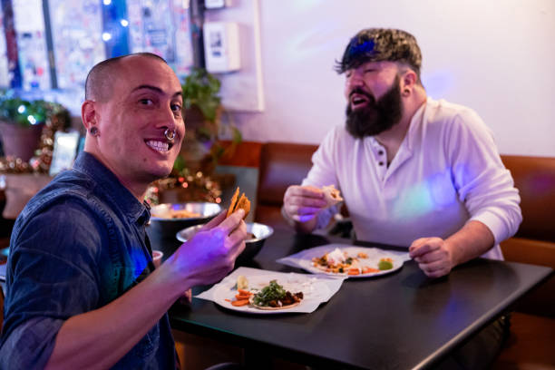 istock Gay couple eating at restaurant 2186692781