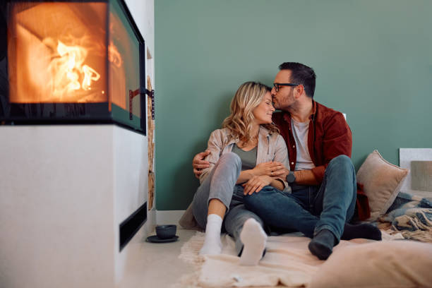 istock Affectionate couple relaxing by the fireplace at home. 2186693807