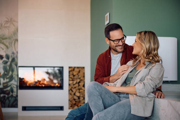 istock Happy couple talking while relaxing in their living room. 2186693809