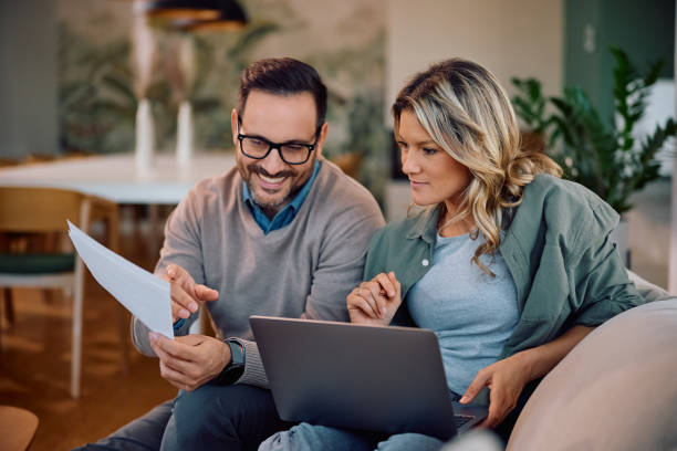 istock Smiling couple going through their home finances at home. 2186693983