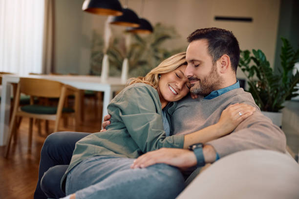 istock Loving couple relaxing with eyes closed on the sofa. 2186694012
