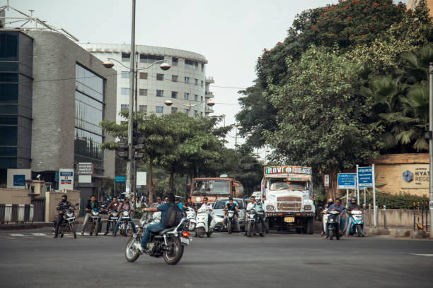 Chennai, India - October 8, 2023. Various forms of transportation wait at a stoplight in Tamil Nadu.