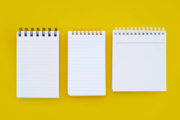 istock To do list note book on yellow background. 2186695604