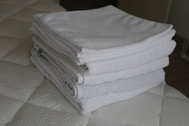 istock Stack of white towels in bed room 2186697486