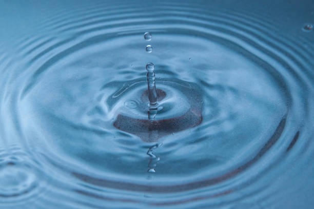istock Circles on the blue surface of the water from the drop falling into it 2186697735