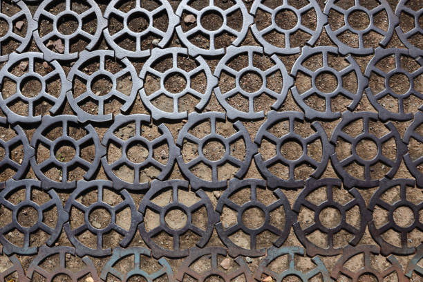 istock Old gray cast iron grate with on the ground. 2186698182