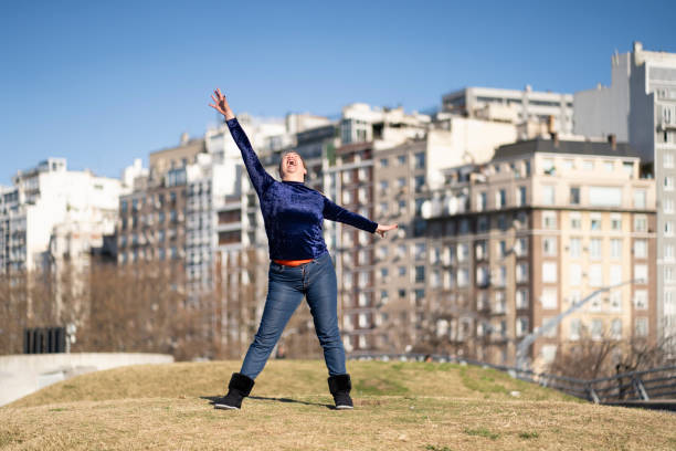 Young happy woman jumping in front of the Eiffel Tower in Paris, France