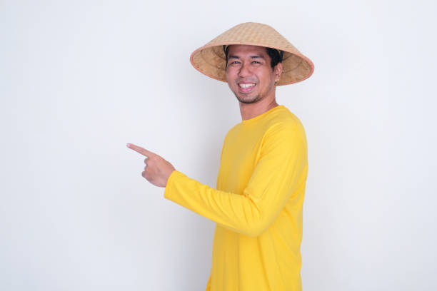istock A farmer smiling confidence with one hand pointing beside him 2186700917