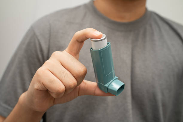 istock Asthma and chronic obstructive pulmonary disease COPD, Asian young man using metered dose inhaler MDI. 2186701252