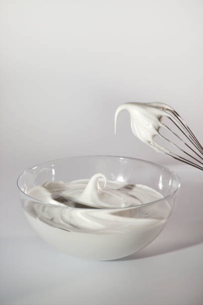 istock Mixing fluffy meringue in a glass bowl with a whisk for baking desserts 2186703232