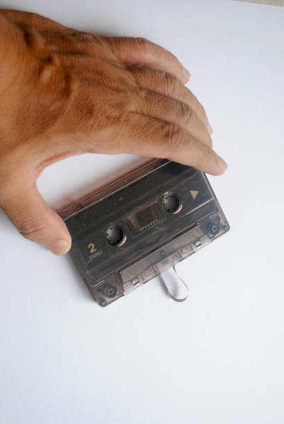 istock Hand holding an audio cassette tape. 2186705546