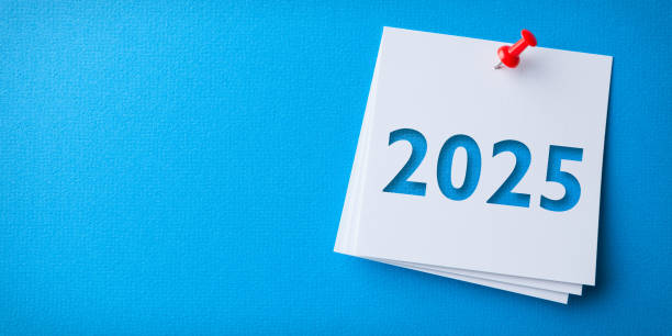 istock White Sticky Note With Happy New Year 2025 And Red Push Pin On Blue Cardboard Background 2186707084