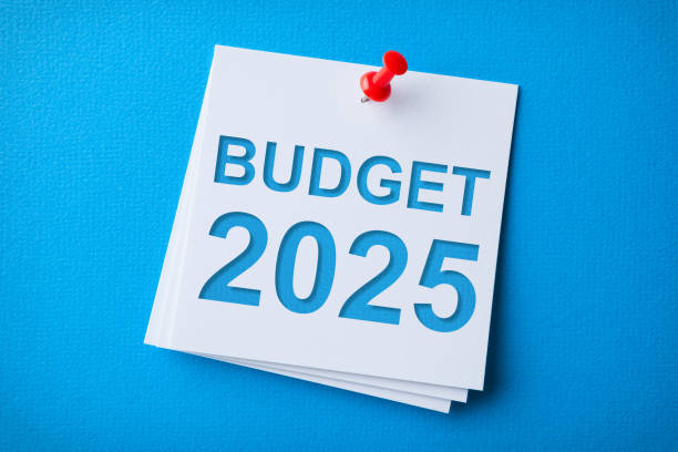 istock Budget 2025 Word in White Sticky Note on Blue Chardboard Background 2186707134