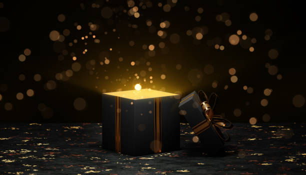 Open black gift box with golden light on dark background for christmas