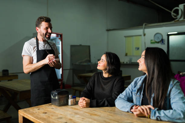 istock Two women at a taco shop table taking an order from a helpful waiter 2186713496