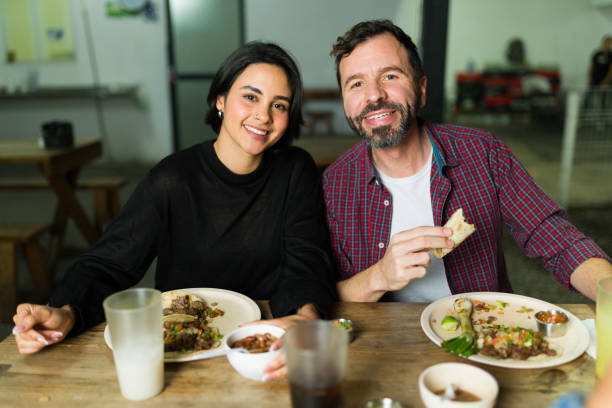 istock Happy hispanic couple savoring authentic flavors while enjoying tacos and drinks at a traditional mexican taqueria 2186716290