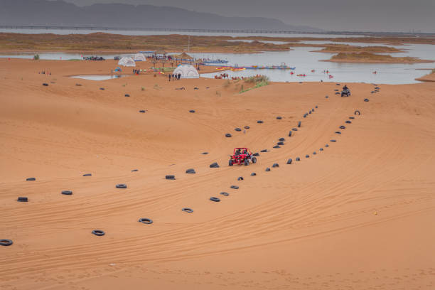 SUV going down a sand dune in the Namib desert at Namib-Naukluft National Park of Namibia, Africa. Landscape photography