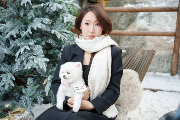 istock Asian woman holding puppy 2186723432
