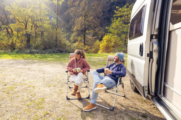 istock Couple Relaxing with Coffee by Camper Van 2186724171