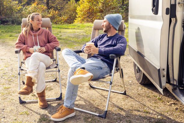 istock Couple Relaxing with Coffee by Camper Van 2186724172