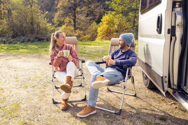 istock Couple Relaxing with Coffee by Camper Van 2186724173