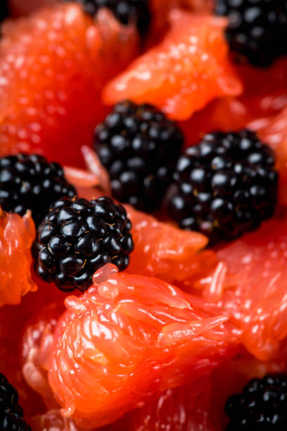 Fruit salad with grapefruit and blackberries in gray ceramic bowl