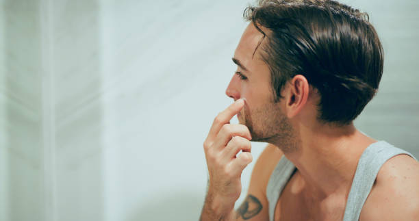 istock Man applying skincare product on face. 2186727736