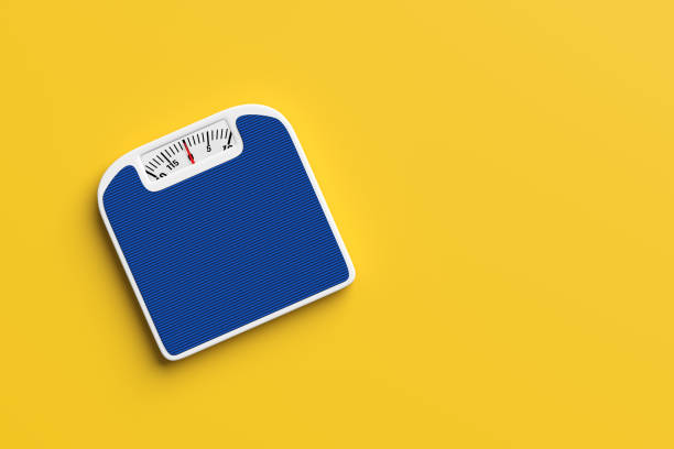 Blue bathroom scale resting on a yellow background, representing health, fitness, and weight management concepts. 3D render.
