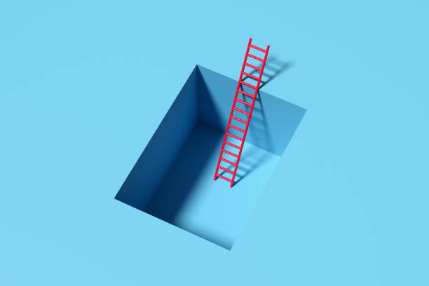 istock Red ladder entering square hole in blue wall symbolizing escape or rescue 2186729110