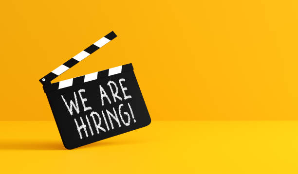 istock Movie clapperboard announcing hiring on yellow background 2186729196